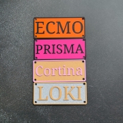 Dog name plate mounted on wire kennel crate at home