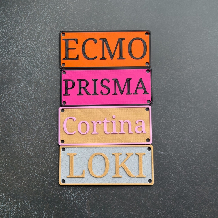 Dog name plate mounted on wire kennel crate at home